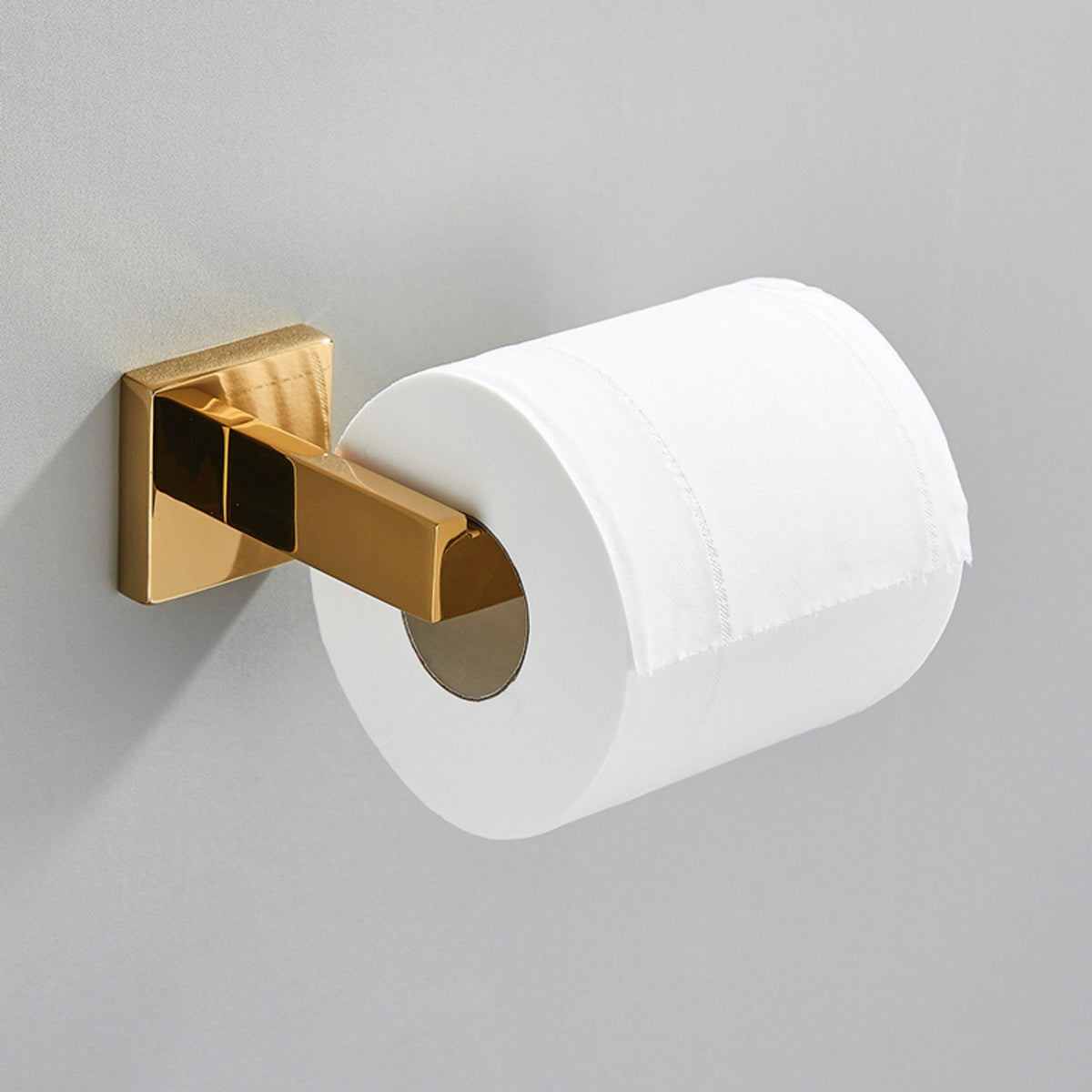Porta papel higiênico dourado em aço inox Shine Homedeccori fixado na parede.
